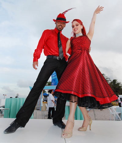 Dancers in 1920s-style costumes performed on a two-foot-high platform situated amid tables in the Deco jazz area.