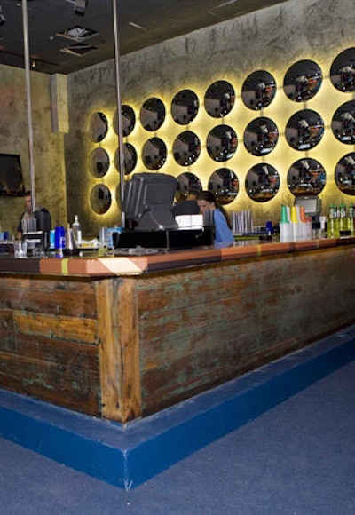 The back wall of the Pleasure Lounge is lined with circular mirrors.