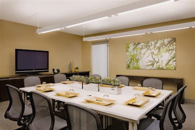 Meeting space feels intimate, with earth-inspired tones and leafy art.