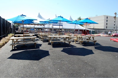 For dining, there are 12 wood picnic tables with blue umbrellas.