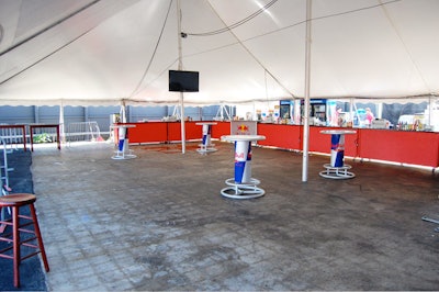 The large tent has a bar, six high-top tables, and two flat-screen TVs.