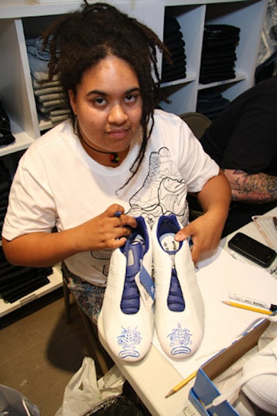 Local artist Chelly personalized 10 pairs of new Originals shoes purchased at the event.