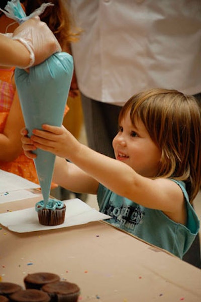 Le Cordon Bleu culinary students and chefs manned a cupcake decorating station for kids.