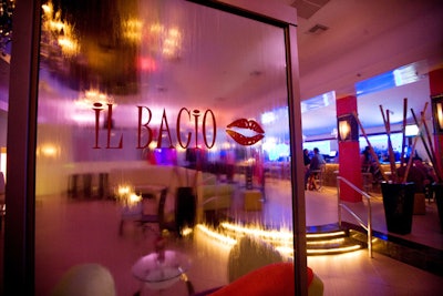 Decor in the main room includes crystal chandeliers, tall bamboo sticks near the bar, and a water wall branded with the venue's name.