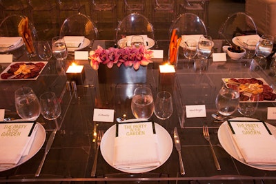 Table arrangements included pink orchids and muted silver vases and candle holders