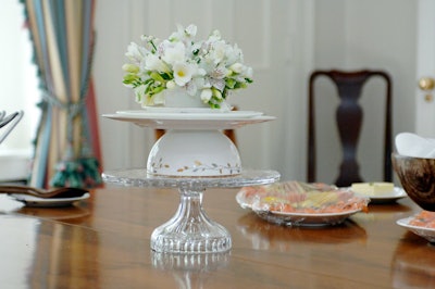 Wedgwood tea cups filled with white flowers topped tables throughout the home.
