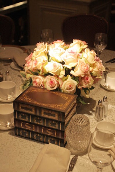 Last year's trompe l'oeil wooden boxes in the shape of books served as centerpieces alongside roses.