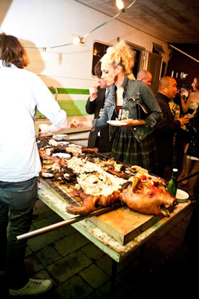 Guests helped themselves to a whole roast pig laid out on a table on the patio.