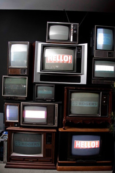 A stack of old televisions in the main party area displayed sponsor logos.