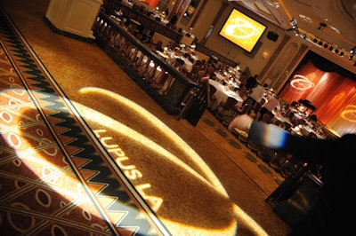 The dining room was lit in shades of orange, along with gobos of the organization's name and logo.