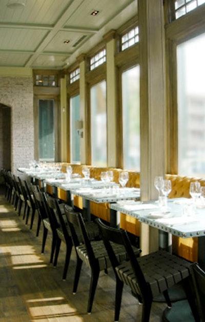 Bright tufted banquettes paired with gray chairs create a modern look in the restaurant.