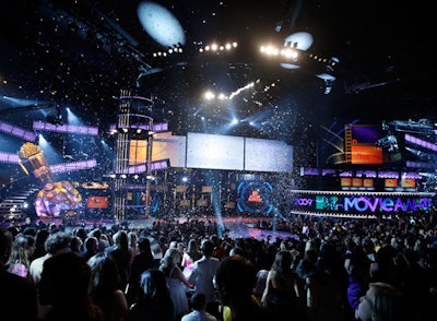 Andy Samberg hosted the MTV Movie Awards on a stage glowing with video displays.