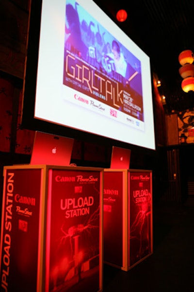 Two illuminated pedestals supported notebook computers where the winning photographers uploaded their images to the Spin Web site.