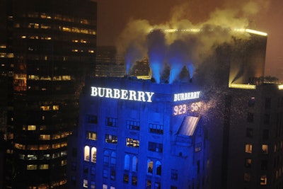 Hidden atop Burberry's Madison Avenue headquarters, 30 double-barreled cannons blasted water-soluble confetti to herald the lighting of the new signs.
