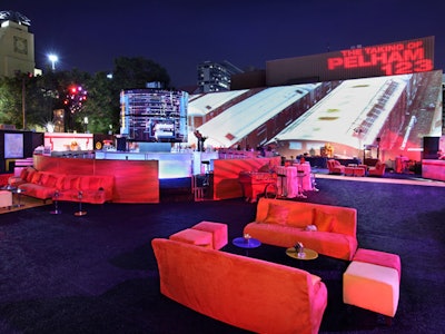 Black Astroturf with colorful subway lines served as the flooring under the party space.