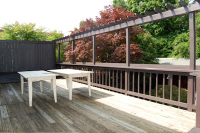 The second-floor deck has a view and a staircase to the landscaped garden below.