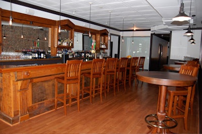 The 110-year-old oak bar near the entrance seats 14.