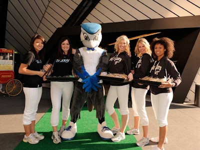 Team mascot BJ Birdie posed for photos with guests on the green carpet at the Bloor Street entrance to the Royal Ontario Museum, where models handed out packages of peanuts.