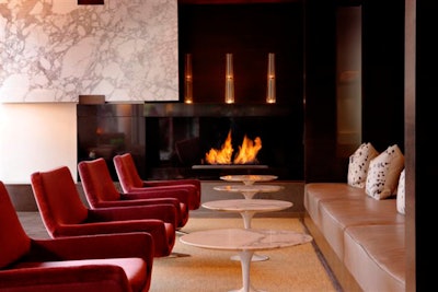 The contemporary lobby decor includes extensive use of white marble and dark wood.