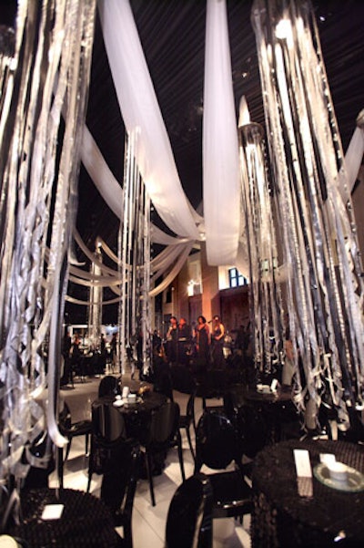 In place of flowers, silver streamers suspended from the ceiling added visual interest to the tent.