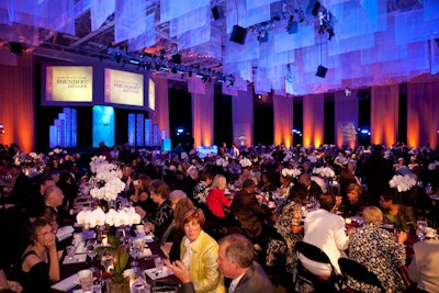 In a break from the supper-club-style seating of years past, communal dinner tables filled the gymnasium's main floor.