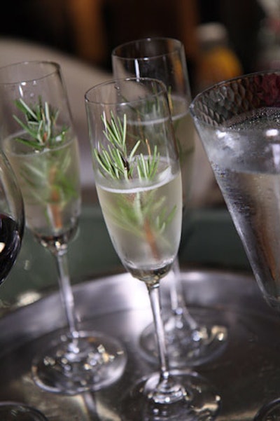 Bartenders served white wine spritzers with fresh herbs.