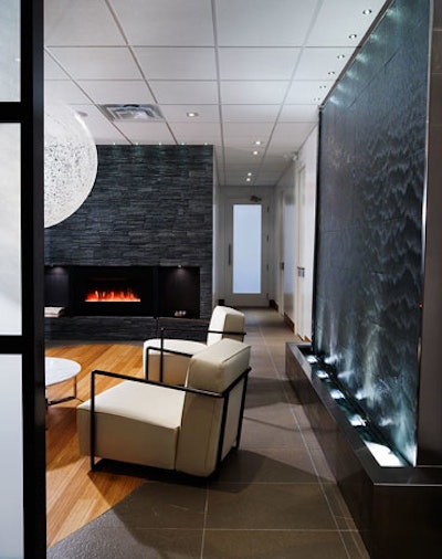 A water feature and fireplace provide focal points in the lounge, which has bamboo floors and white furnishings.