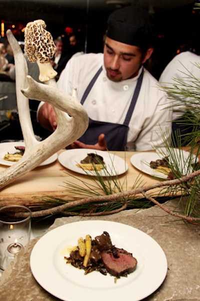 Chef Michael Stadtländer's food station was decorated with branches, slabs of wood, and wild mushrooms.