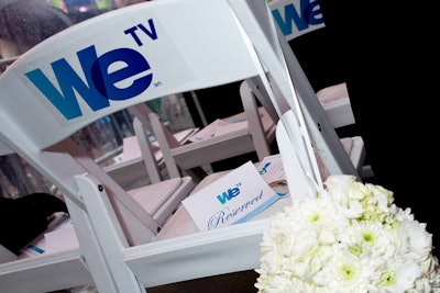 Inside the tent on Military Island, WE TV set up a small seating area complete with white chairs and wedding-style floral arrangements.