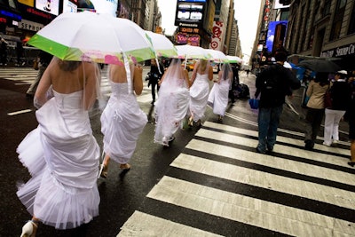 Before entering the tent, the procession of five brides navigated Times Square.