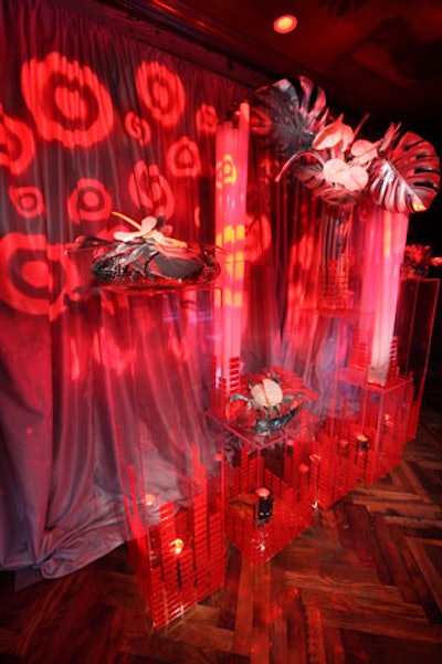 Metallic palm fronds and tubes of fluorescent lights punctuated the futuristic floral arrangements in transparent glass vases.