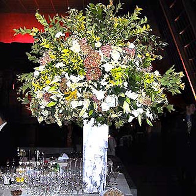 One of Avi Adler's large buffet table arrangements featured white roses, hydrangea, and lilies in custom-made brushed steel vases.