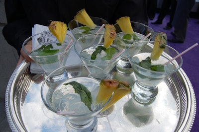 Servers passed mojitos to guests at they arrived.
