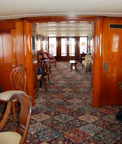The main salon has original walnut paneling and 1920's decor.