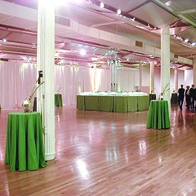 The cocktail area was decorated with light green lights from Stortz Lighting, green tablecloths and small flower and candle arrangements from Daily Blossom.
