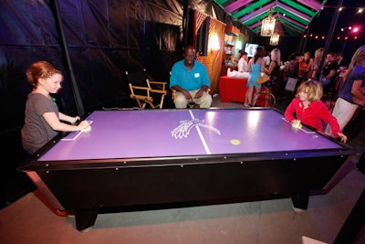 An air hockey table decked a sports bar theme area.