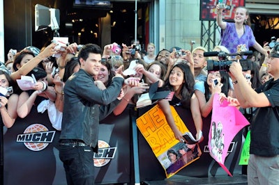 More than 6,000 fans filled the MuchMusic parking lot and lined Queen Street, where Twilight actor Taylor Lautner signed autographs on the red carpet.