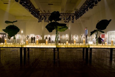 In the gallery section of the event, flickering votives and oversize fronds topped an 18-foot-long illuminated acrylic-top communal table.
