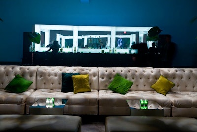 Two 20-foot-long tufted white leather Chesterfield sectionals were paired back-to-back at the entrance to the party.