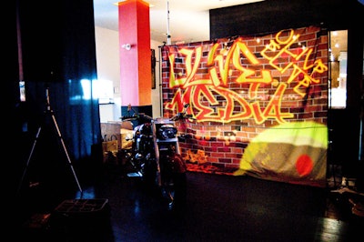 Guests could have their photos taken sitting on a Harley-Davidson placed in front of a backdrop with an Olive Media graffiti tag.