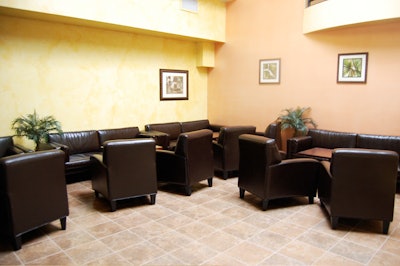 On the ground level, the 25-seat lounge area has dark brown sofas and club chairs.