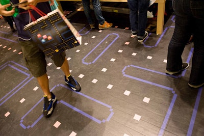 For the month leading up to the competition, Uniqlo covered the mezzanine floor in Pac-Man's labyrinthine playing field.