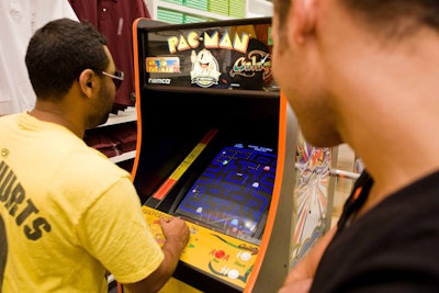 On either side of the floor, teams played on two Pac-Man machines brought in for the event and the ongoing promotion.