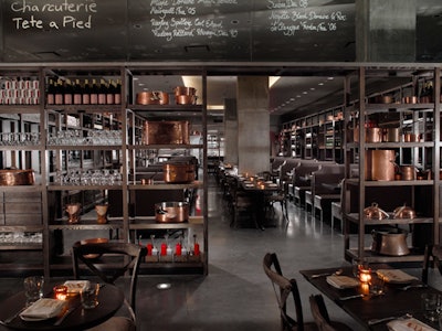The bar and cafe area in the front is separated from the main dining room by a series of shelves.