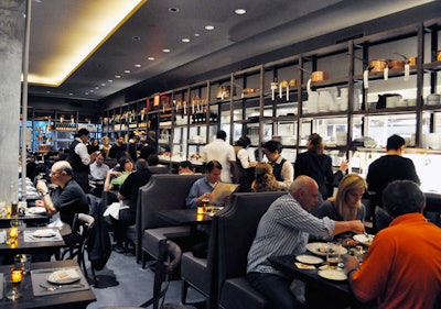 The 140-seat dining room is furnished with comfortable booths and offers partial views into the kitchen.