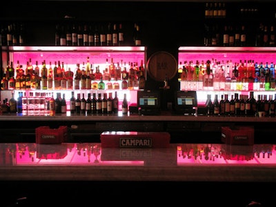 Red lighting illuminates the back of the bar.