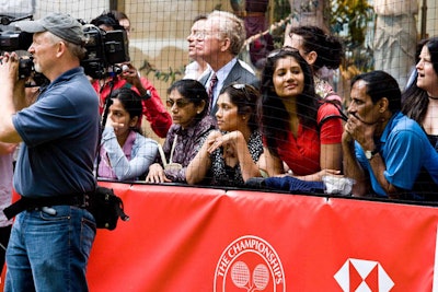 Passersby stopped and took in the matches, which included ones with professionals Jim Courier and Jennifer Capriati on the opening day.