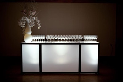 At the Ivy Room fashion show, white floral arrangements topped illuminated bars.