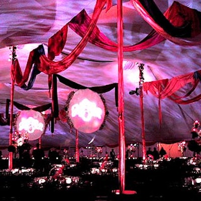 At the Central Park Conservancy's Raise Your Spirits Halloween Ball at the Central Park Bandshell, Matthew David Events draped red, fuschia and violet fabric along the tent piping, and Bentley Meeker shone the sorceress logos on two white disks trimmed with floral garlands.