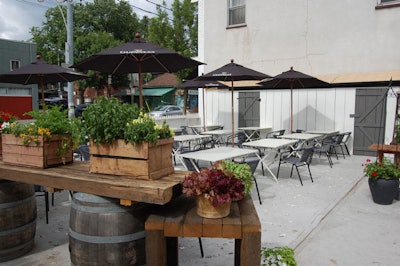 A white picket fence surrounds the 40-seat patio, which has oyster shells embedded in the concrete patio surface.